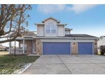 Charming two-story home with a two-car garage and covered front porch at 8613 Midsummer Dr, Indianapolis, IN 46239