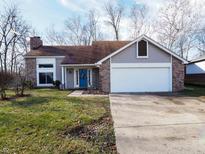 Brick ranch home with attached garage and landscaped lawn at 944 Brendon Dr, Plainfield, IN 46168