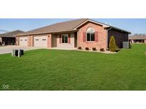 Brick ranch home with attached garage and landscaped lawn at 202 Asbury Dr, Anderson, IN 46013