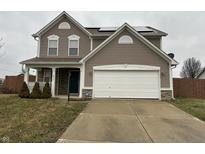 Two-story house with taupe vinyl siding, a white garage door, and a well-maintained lawn at 672 Rocky Meadow Dr, Greenwood, IN 46143