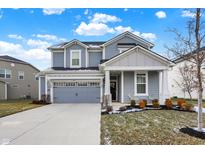 Two-story house with gray siding, white accents, and a two-car garage at 15449 Staffordshire Way, Fishers, IN 46037