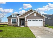 Craftsman style home with brown siding, white garage door, and stone accents at 19689 Highclere Ln, Westfield, IN 46069