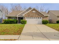 Brick ranch home with a 2-car garage and well-manicured lawn at 4845 Ventura Blvd, Plainfield, IN 46168