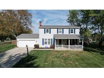 Two-story house with gray siding, blue shutters, and a covered porch at 6031 S Eaton Ave, Indianapolis, IN 46259