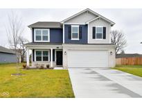 Two-story home with navy blue and beige siding, white garage door, and landscaped lawn at 6329 Basden Dr, Indianapolis, IN 46221