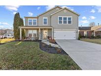 Two-story house with gray siding, attached garage, and landscaped lawn at 9549 W Quarter Moon Dr, Pendleton, IN 46064