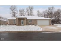 Brick ranch home with attached garage and snow-covered lawn at 111 Independence Ave, Anderson, IN 46012