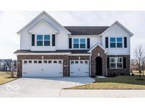 Two-story home with white siding, brick accents, and a three-car garage at 2400 Oakmont Dr, Plainfield, IN 46168