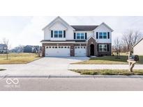 Two-story house with white siding, brick accents, and a three-car garage at 2400 Oakmont Dr, Plainfield, IN 46168