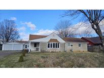 Ranch home with stone facade, attached garage, and landscaped yard at 2640 E Midland Rd, Indianapolis, IN 46227