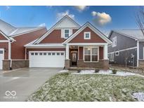 Brick and shingle two-story home with a covered porch and two-car garage at 3923 Holly Brook Dr, Westfield, IN 46062