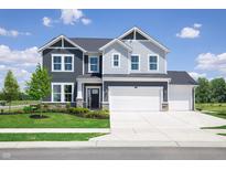 Two-story home with gray and white siding, three-car garage, and landscaped lawn at 595 Bluestem Ln, New Whiteland, IN 46184