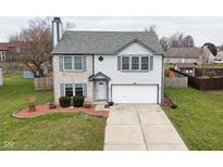 Two-story brick home with attached garage and landscaped yard at 139 Fountain Dr, Mooresville, IN 46158