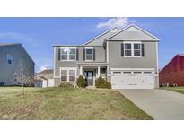Two-story gray house with white garage door and landscaping at 2034 Buckthorn Dr, Columbus, IN 47201