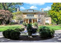 Grand two-story home with a green tile roof and manicured lawn at 4621 N Meridian St, Indianapolis, IN 46208