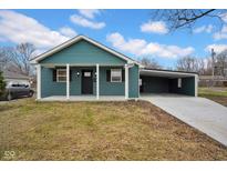 Newly constructed teal home with carport and landscaping at 5184 N Vance St, Columbus, IN 47201