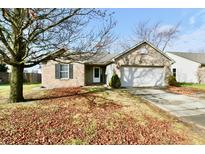 Brick ranch home with attached garage and mature tree in the front yard at 6123 Boulder Dr, Anderson, IN 46013