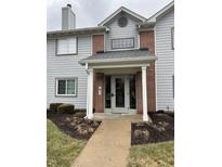 Condo building entrance with brick and gray siding at 8120 Glenwillow Ln # 103, Indianapolis, IN 46278