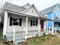 Charming one-story home with a front porch and red door at 2134 Pleasant St, Indianapolis, IN 46203