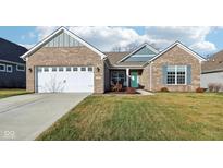Brick house with 2-car garage, landscaped yard, and a teal front door at 5142 Citadel Dr, Noblesville, IN 46062