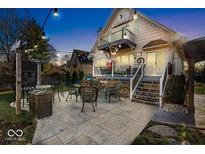 Spacious backyard patio with seating area, fire pit, and string lights at 2222 E 75Th St, Indianapolis, IN 46240