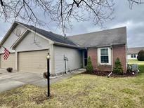 Brick and vinyl ranch home with 2-car garage and landscaped yard at 7254 Broyles Ln, Indianapolis, IN 46217