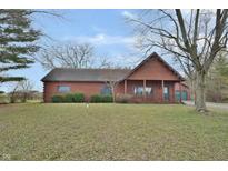 Rustic log cabin home with a spacious yard at 5360 N Carroll Rd, Indianapolis, IN 46235