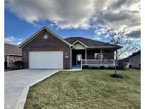 Brick ranch home with attached garage and landscaped lawn at 5375 E Commons West Dr, Mooresville, IN 46158