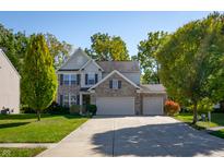 Brick two-story house with a three-car garage and a landscaped lawn at 1167 Old Vines Ct, Greenwood, IN 46143