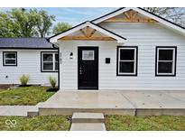 White house with black accents, new landscaping, and a modern design at 3702 N Euclid Ave, Indianapolis, IN 46218