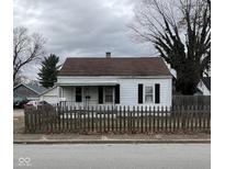 Cute white house with a brown roof and picket fence at 640 S Sycamore St, Martinsville, IN 46151