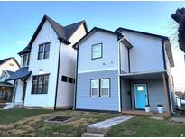Two-story modern home with gray and white siding, a light blue door, and landscaping at 305 Parkway Ave, Indianapolis, IN 46225
