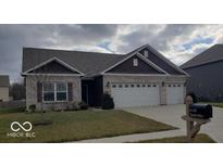 House exterior with a three-car garage and mailbox at 9149 Thames Dr, Avon, IN 46123