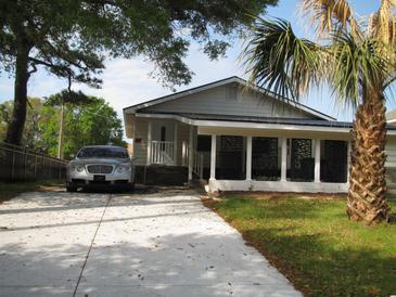 A charming single-story home with a spacious driveway and lush landscaping at 209 A/B 26Th Ave. S, Myrtle Beach, SC 29577