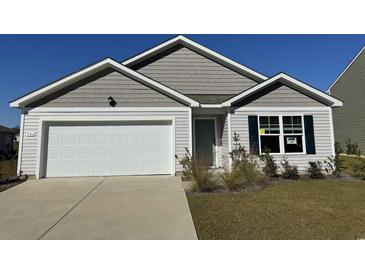 Gray and white charming house with a two-car garage and manicured lawn at 504 Strawberry Field Way, Galivants Ferry, SC 29544