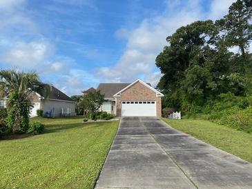 Brick house with a two-car garage and manicured lawn at 333 William St., Myrtle Beach, SC 29577