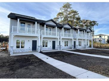 Three-unit townhome building with gray siding, white trim, and stone accents at 850 Maxine Ct. # 5A, Myrtle Beach, SC 29577