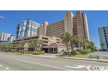 Sandcastle South Oceanfront resort building exterior, featuring parking and landscaping at 2207 S Ocean Blvd. # 1015, Myrtle Beach, SC 29577