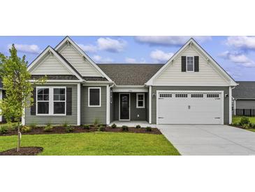 Two-story house with gray siding and a two-car garage at 1906 Woodrush Loop, Little River, SC 29566