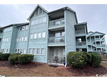 Light blue three-story building with multiple balconies and landscaping at 5905 South Kings Hwy. # 6110-D, Myrtle Beach, SC 29575