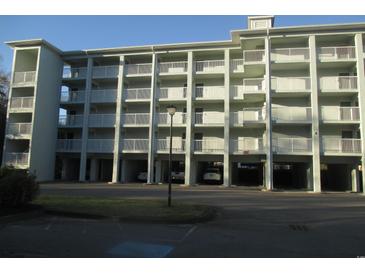 Three-story building with parking and balconies at 14290 Ocean Hwy. # 103, Pawleys Island, SC 29585