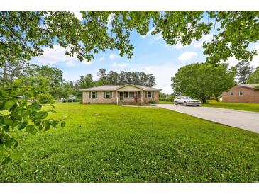Brick ranch house with a large yard and driveway at 129 Meadowview Rd., Marion, SC 29571