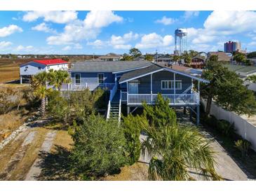 Elevated home with gray siding, deck, and water views at 410 N 28Th Ave. N, North Myrtle Beach, SC 29582