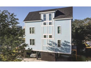 Elevated light blue home with a spacious garage at 116 Tidal Creek Dr., Murrells Inlet, SC 29576