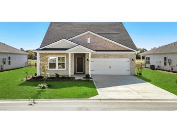 Brick home with a two-car garage and landscaped lawn at 555 Cypress Preserve Circle, Longs, SC 29568