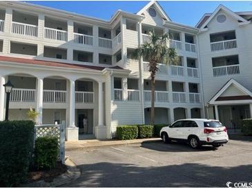 Three-story building with balconies and parking at 4601 Greenbriar Dr. # 206A, Little River, SC 29566