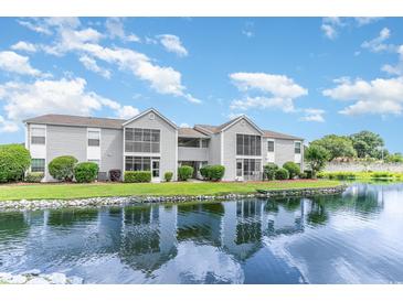 Gray siding condo building with water view at 8725 Chandler Dr. # F, Surfside Beach, SC 29575