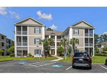 Two story beige building with screened porches at 242 Sun Colony Blvd. # 101, Longs, SC 29568