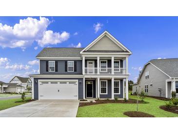 Two-story home with gray siding, white trim, and a two-car garage at 297 Broughton Dr., Myrtle Beach, SC 29579