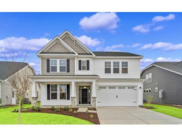 Two-story house with gray and white siding, stone accents, and a two-car garage at 315 Broughton Dr., Myrtle Beach, SC 29579